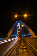 Fototapeta na wymiar Apollo Bridge in Baratislava Slovakia at night from the middle of the highway