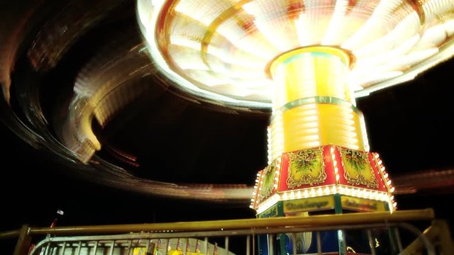 A swing carousel rotating rapidly.