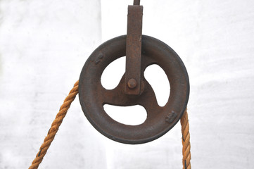 Iron pulley with jute rope.