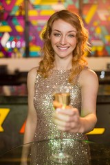 Young woman holding a glass of champagne © WavebreakmediaMicro
