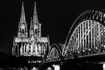 Cologne Cathedral with the Hohenzollern Bridge in Cologne Germany in black and white