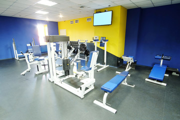 Fototapeta na wymiar Interior of a fitness hall with sport equipment