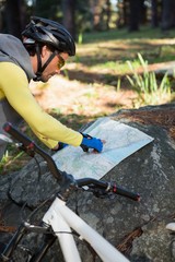 Mountain biker looking at map