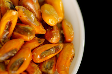 Small white bowl of delicious fried chochos, south american specialty side snack, as seen from above