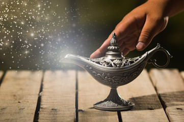 Beautiful antique metal lamp in true Aladin style, hand touching and animated star dust coming out,...