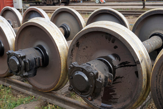New and spare railway wheels on the axle in a repair workshop
