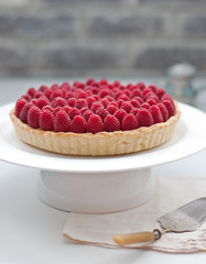 Raspberry tart on a white plate Selective focus