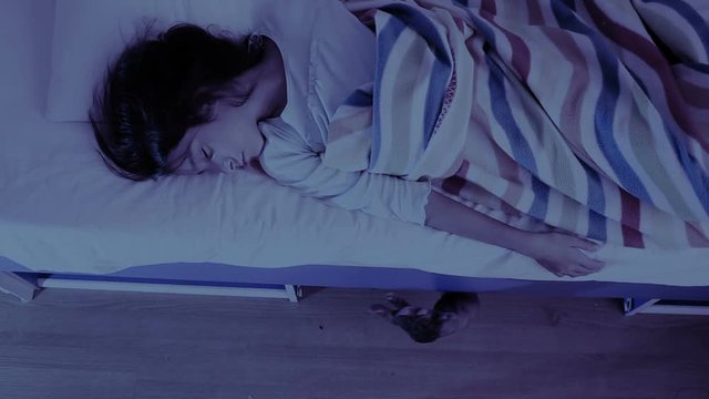 monster coming out from under little girls bed. nightmare child. halloween