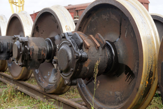 New and spare railway wheels on the axle in a repair workshop
