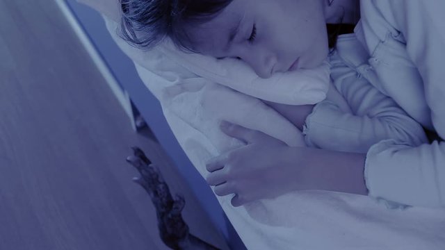 monster coming out from under little girls bed. nightmare child. halloween