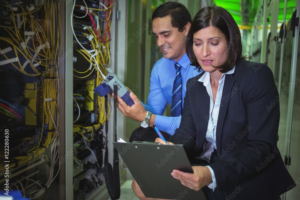 Poster Technicians analyzing rack mounted server