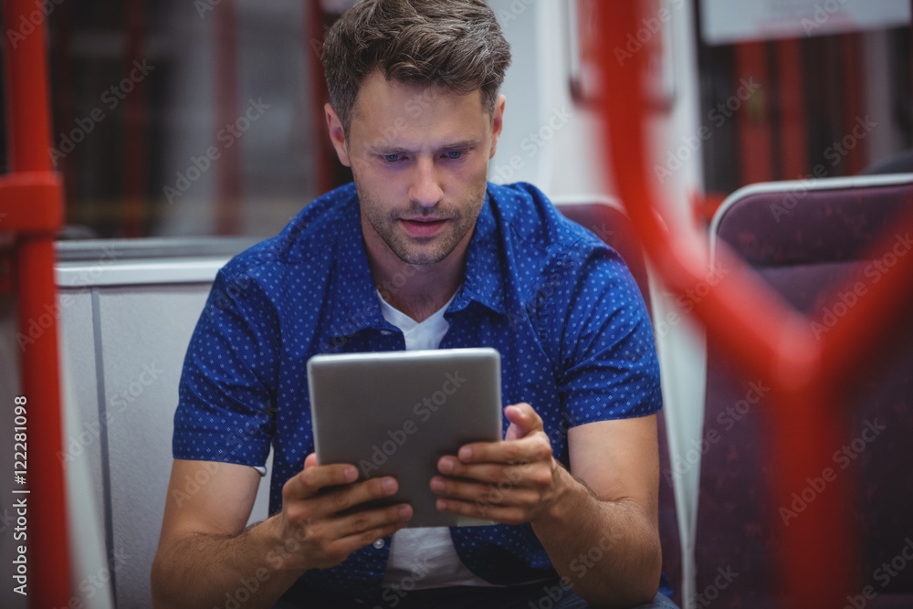 Poster handsome man using digital tablet in train