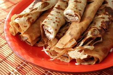 Pancakes on orange plate