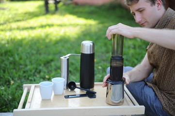 Man making coffee in nature
