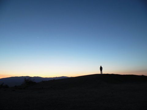 Silhouette Of Person Standing On Hill