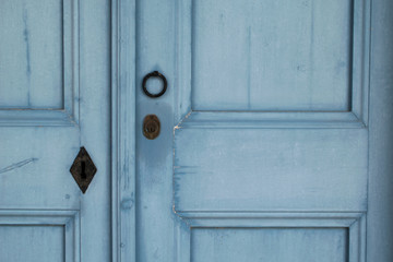 Knocker and lock on the blue wooden door