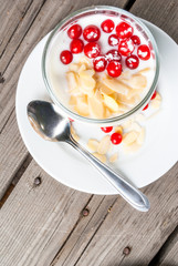 Light and healthy breakfast: oatmeal with yogurt, almonds and berries. Top view, copy space