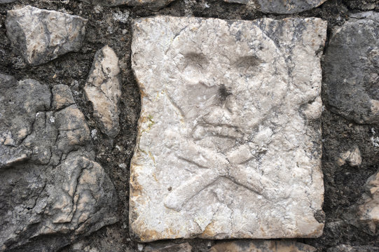 skull and cross bones on the tombstone