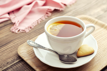 Cup of tea with lemon and cookies