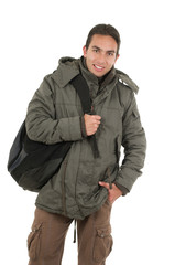 latin  guy wearing coat and backpack posing with hand on pocket