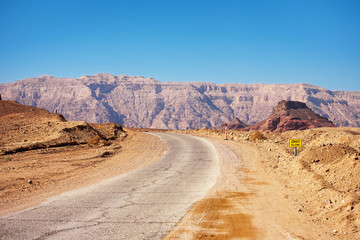 Fototapeta na wymiar Road running through Timna National Park in the Negev Desert nea