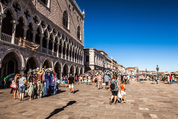 VENICE, ITALY - AUGUST 17, 2016: Tourists on streets of Venice on August 17, 2016 in Venice, Italy.