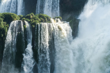 Close up of Iguazu falls with sun shading on the falls, Argentin
