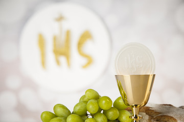 Holy communion a golden chalice, composition isolated on white
