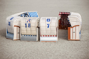 typical Northern German beach chairs, called Strandkorb, standing in a round