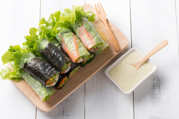 salad roll on white wood background