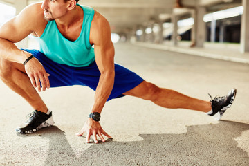 Close up of male runner doing stretching exercise
