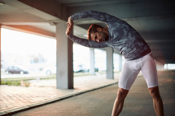 Young man stretching after running