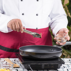 Chef putting mushroom  to the pan