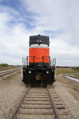 Orange and black diesel locomotive - portrait view