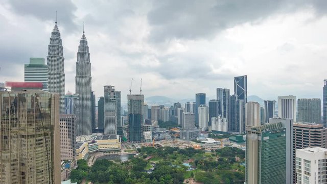 Cloudscape aerial view of Kuala Lumpur city skyline. Time lapse. Pan left