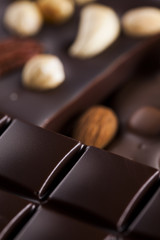 Dark homemade chocolate bars and cocoa pod on wooden