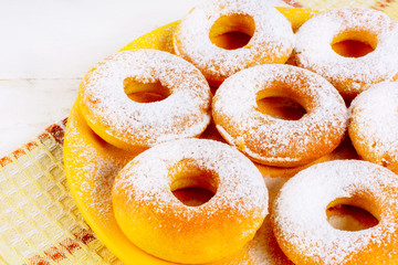 Sweet donuts served on yellow plate