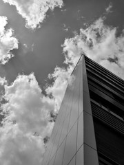 Low angle view on building and clouds in black and white