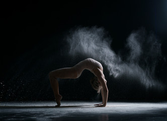 Dancer performs acrobatic trick in cloud of dust