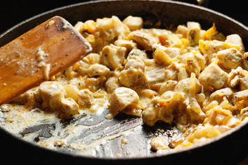 Cooking chicken pieces on a pan