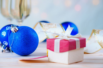 Gift box, glasses of champagne and christmas balls