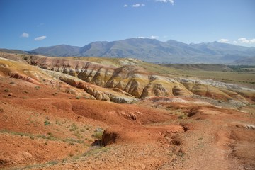 Summer mountains landscape with multicolored earth