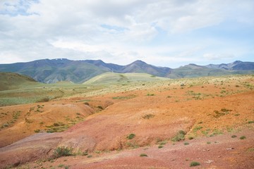 Summer mountains landscape with multicolored earth