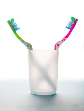 two toothbrushes in a glass