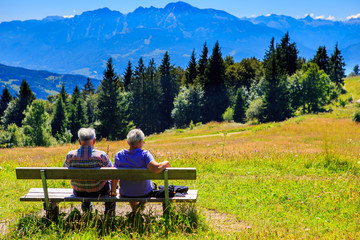 Altes Ehepaar auf Bank in den Alpen