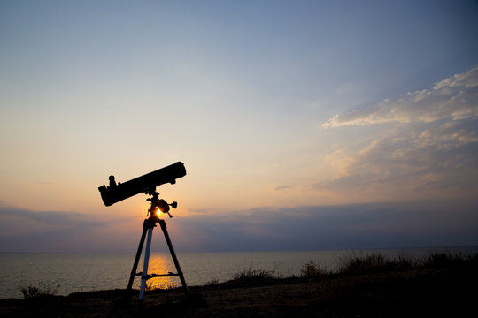 telescope silhouette at sunset background