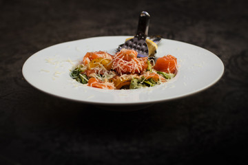 Fish salad. Salmon, vegetables and lemon