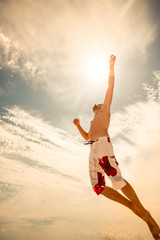 Obraz premium male beach volleyball game player jump on hot sand