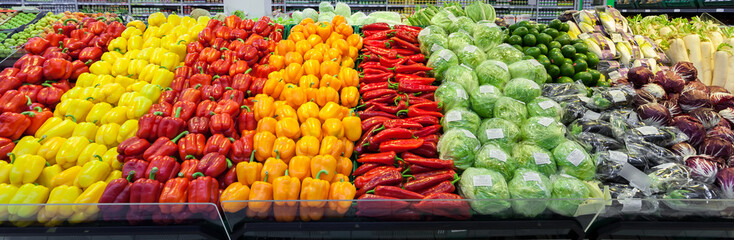 Supermarket vegetables showcase with pepper and cabbage