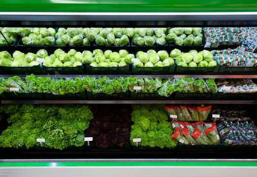 Supermarket vegetables showcase with cabbage and salad
